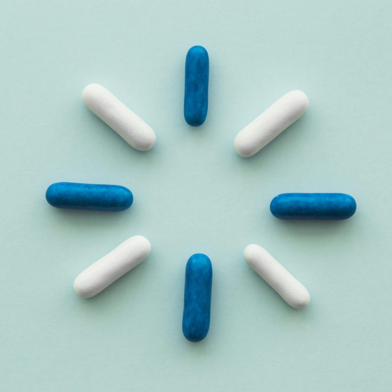 design-made-with-blue-white-capsules-blank-background
