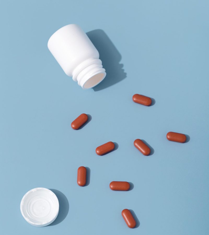 flat-lay-red-pills-with-container